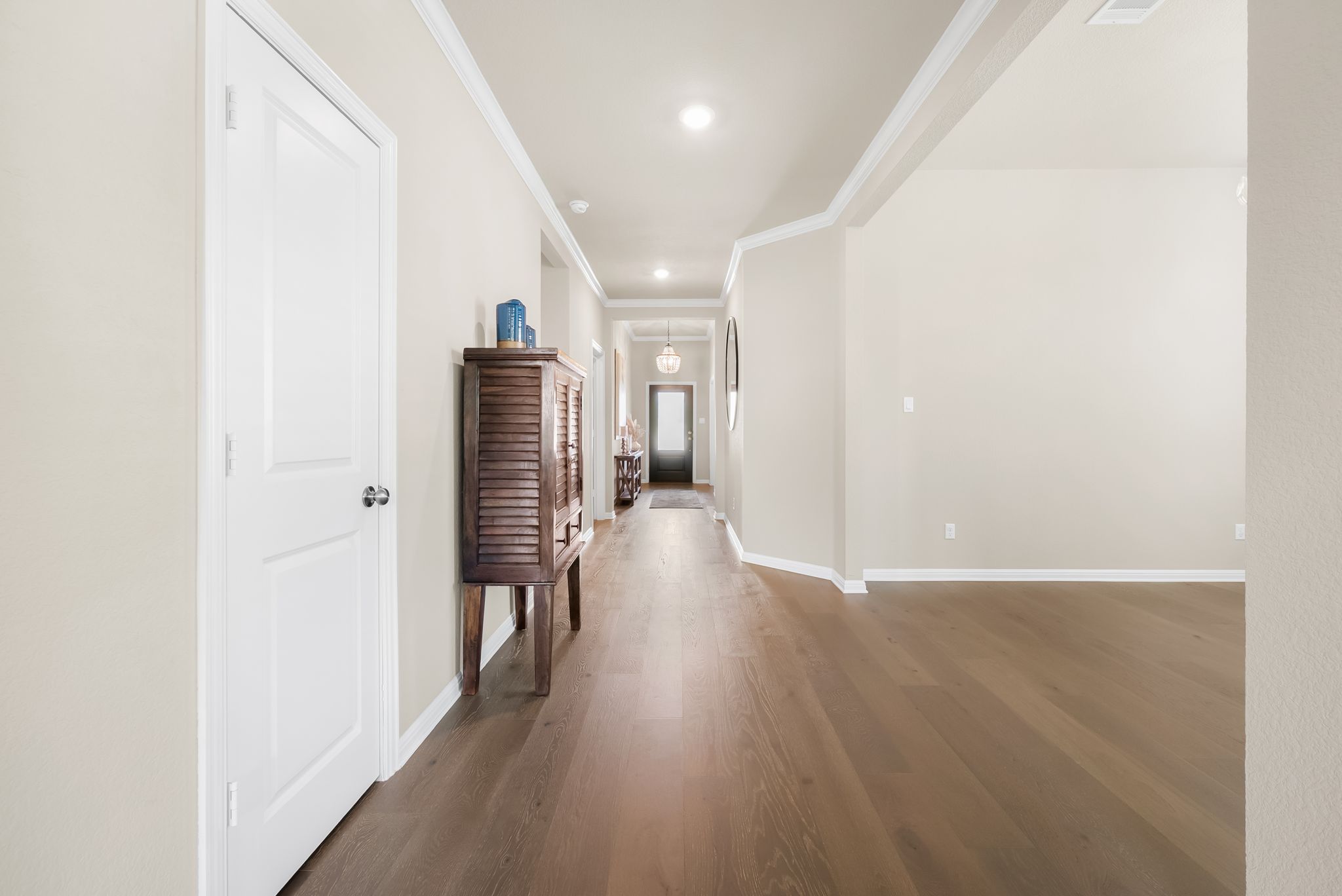 300 Prato Place Georgetown, TX 78628 - Photo 30 of 40 An inviting entry hallway with rich hardwood flooring leads to an open living area.