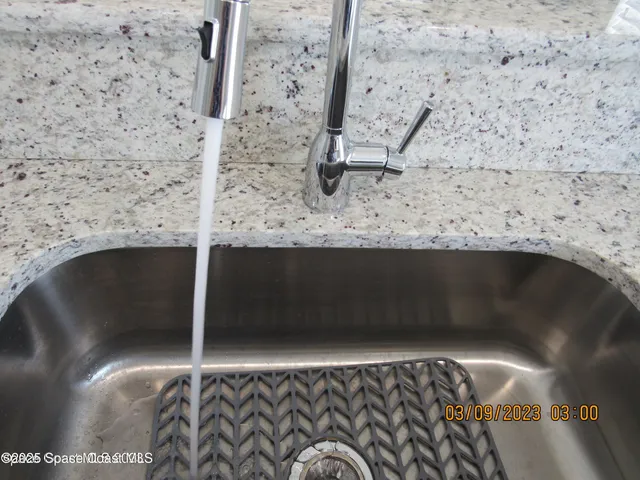 a kitchen with cabinets and stainless steel appliances