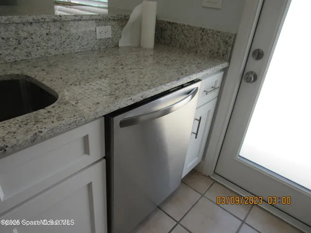a kitchen with a refrigerator and a stove