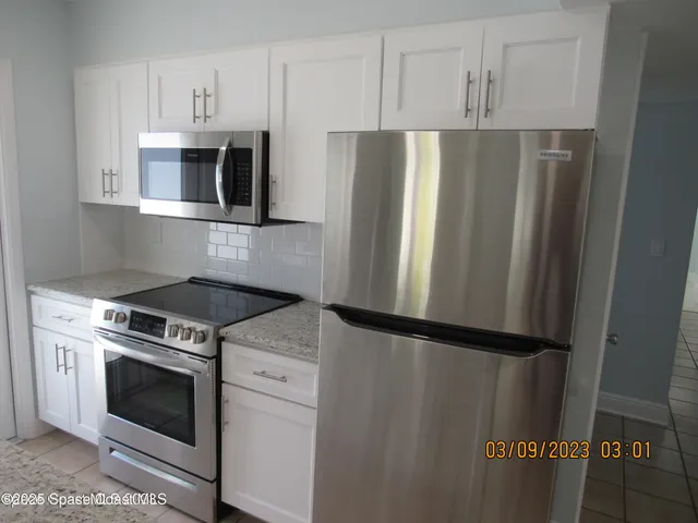a view of hallway with a rug and a window