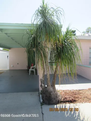 a kitchen with refrigerator and chairs