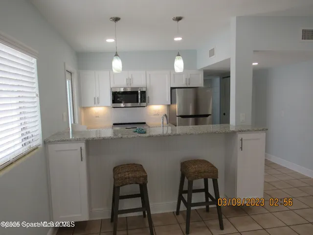 a view of a kitchen from the hallway