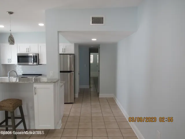 a kitchen with stainless steel appliances granite countertop a sink and a white cabinets