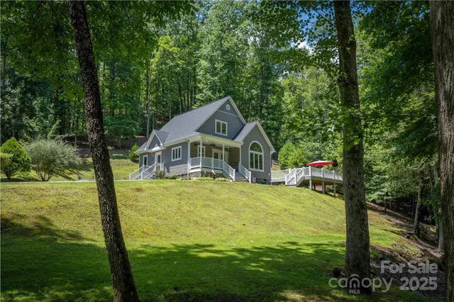 a bedroom with a bed and a dresser with wooden floor