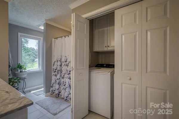 a kitchen with stainless steel appliances a refrigerator and a window