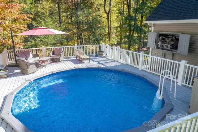 swimming pool view with a seating space