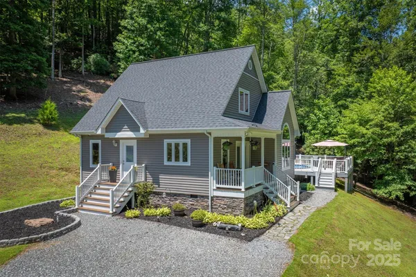 an aerial view of a house with swimming pool and porch