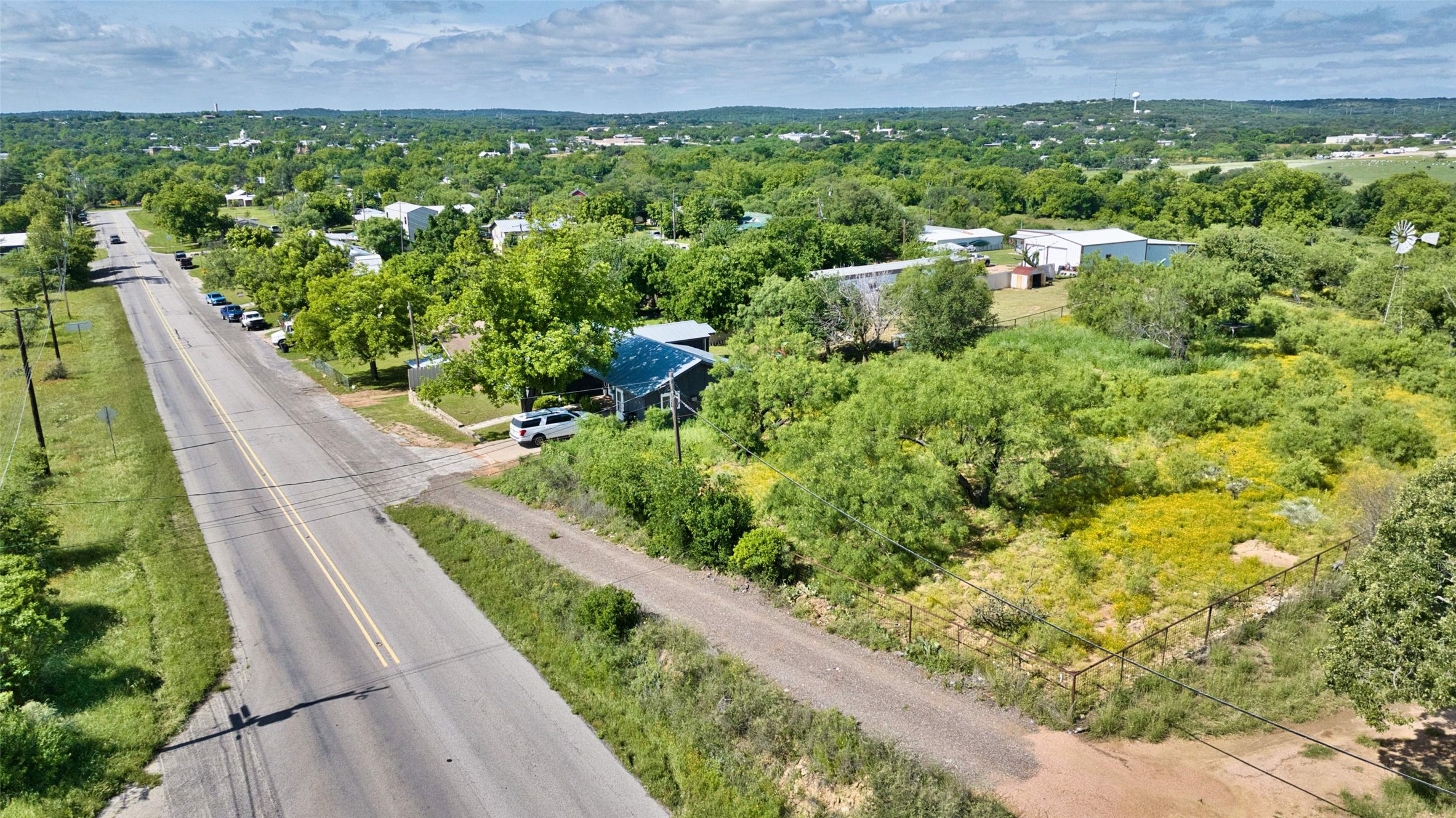 904 Bluebonnet Road Mason, TX 76856 - Photo 7 of 28 Expansive property featuring a paved road frontage, mature trees, and natural landscaping