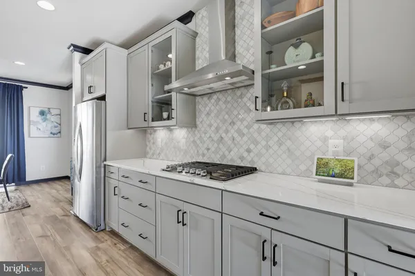 a kitchen with stainless steel appliances granite countertop a refrigerator and a stove