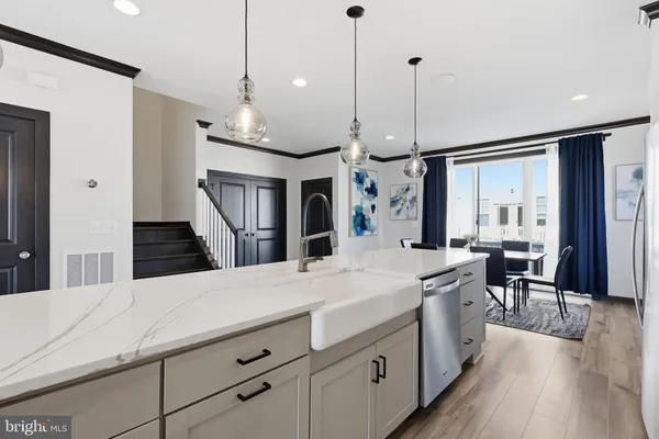 a large kitchen with kitchen island a large counter space a sink appliances and cabinets