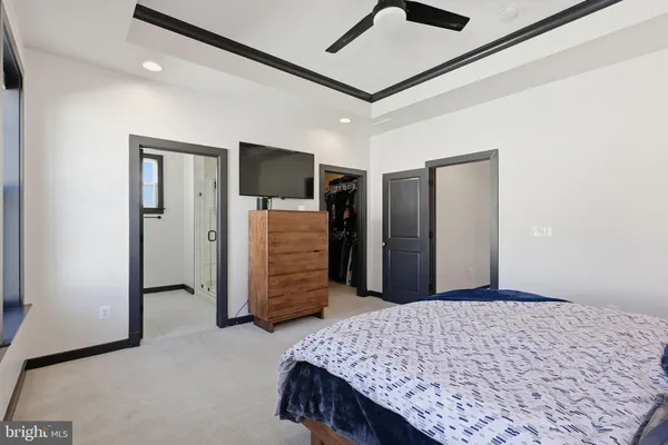 a bedroom with a bed and a television