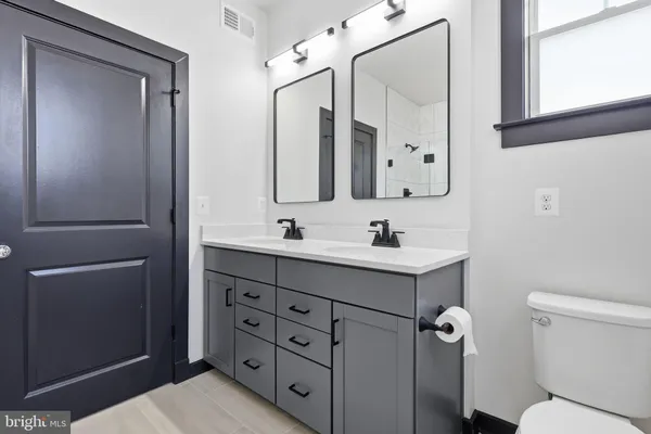 a bathroom with a sink toilet and mirror