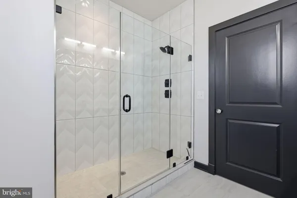 a bathroom with a glass shower door