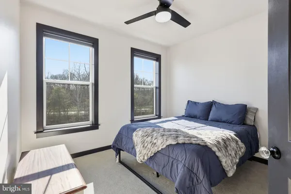 a bedroom with a large bed and a window