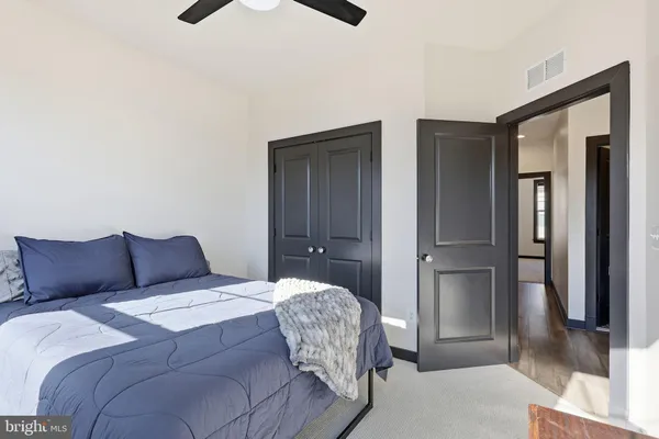 a bedroom with a bed and a large mirror