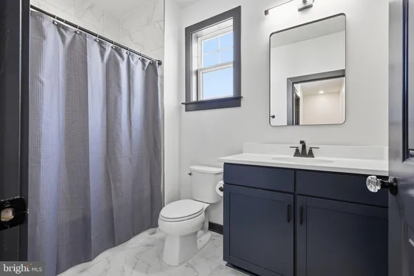 a bathroom with a sink a toilet and mirror