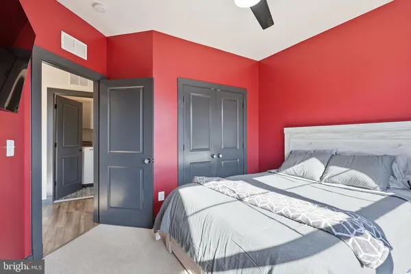 a bedroom with a bed and a potted plant