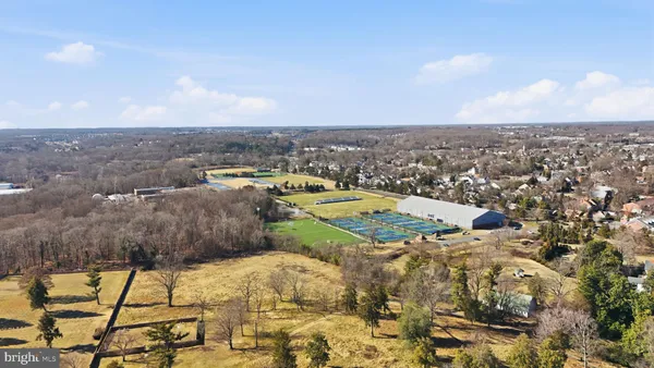 a front view of a building with cars parked