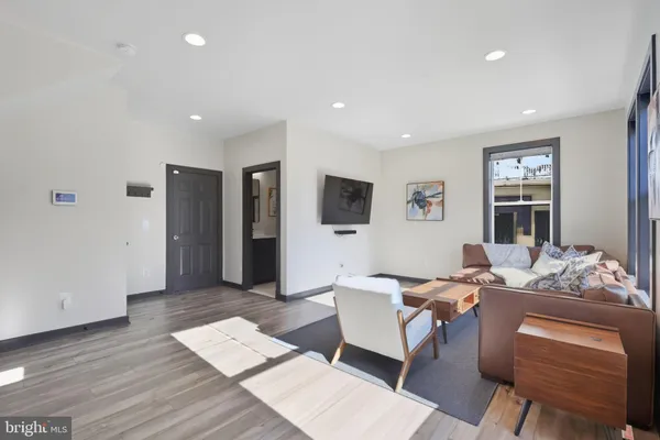 a living room with furniture and wooden floor