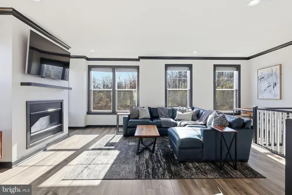 a living room with furniture fireplace and flat screen tv