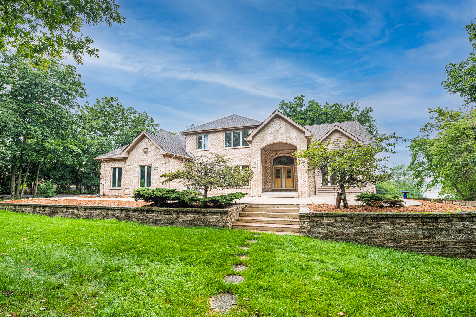1071 Bonner Road Wauconda, IL 60084 - Photo 1 of 61 a front view of a house with a garden and yard