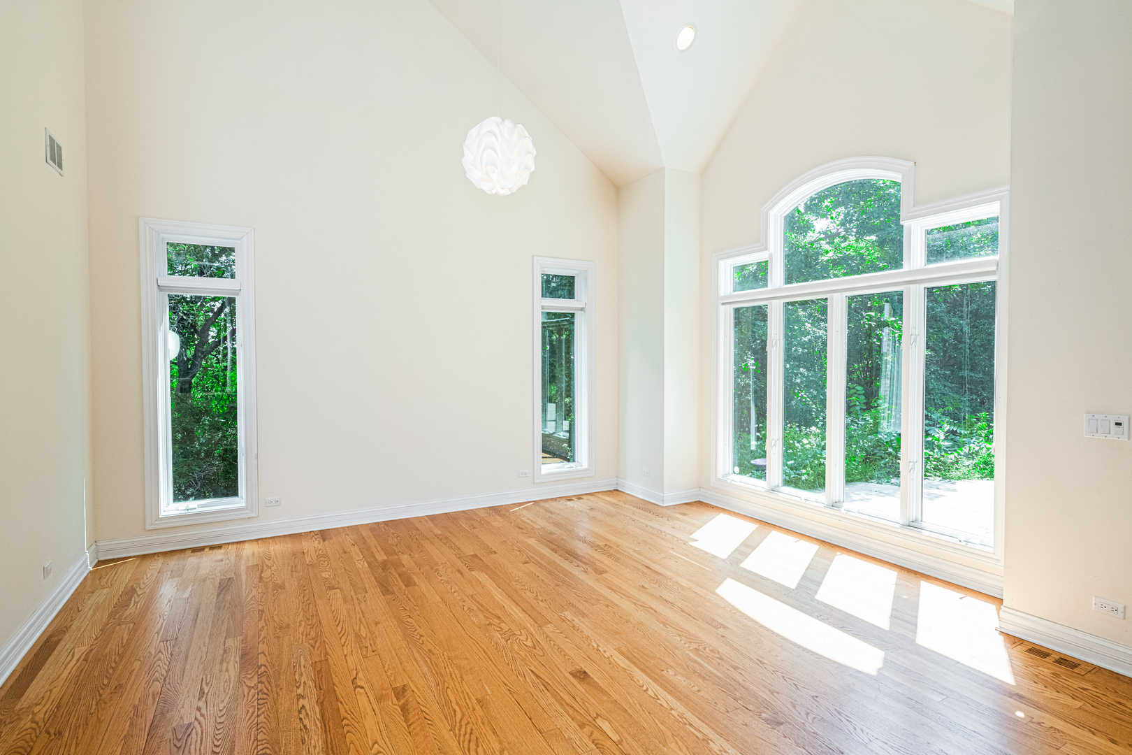 1071 Bonner Road Wauconda, IL 60084 - Photo 13 of 61 a view of an empty room with wooden floor and a window