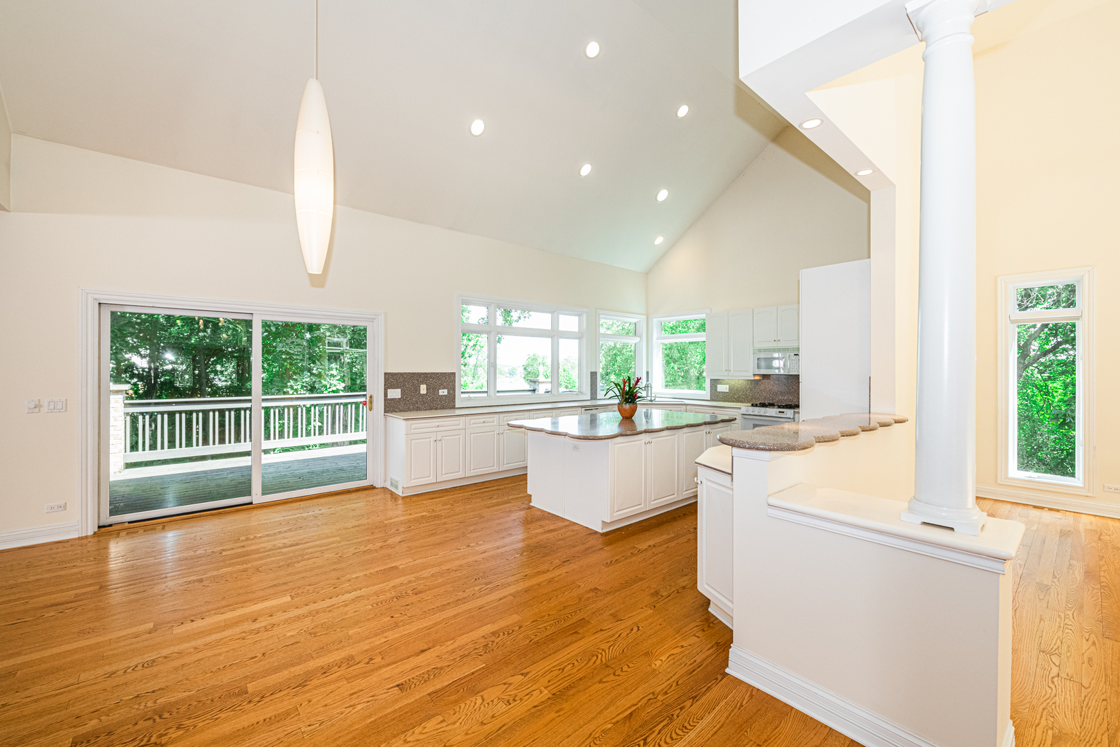 1071 Bonner Road Wauconda, IL 60084 - Photo 15 of 61 a large kitchen with kitchen island a large window a sink and white cabinets