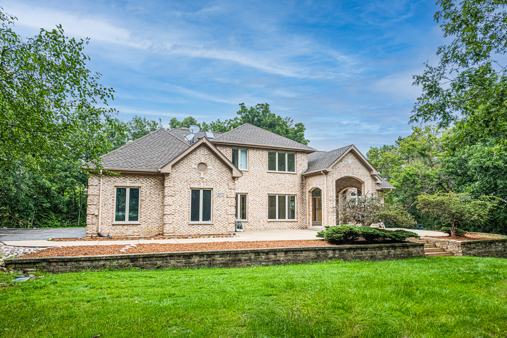 1071 Bonner Road Wauconda, IL 60084 - Photo 3 of 61 a front view of a house with a garden