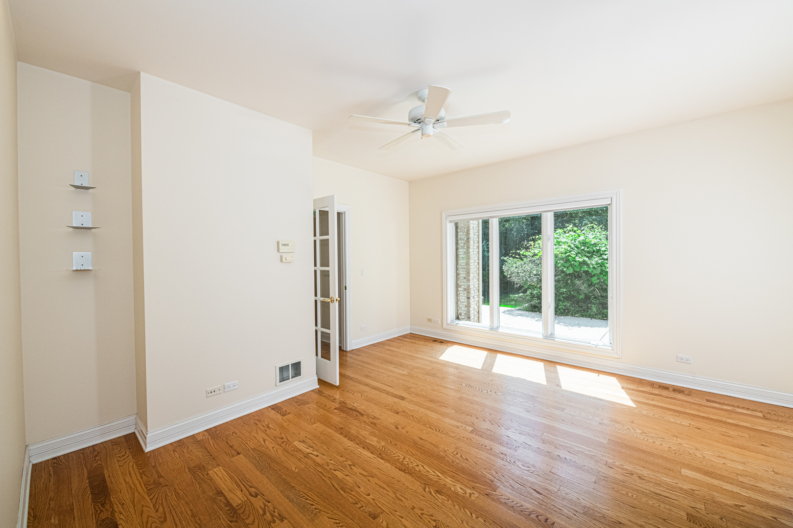 1071 Bonner Road Wauconda, IL 60084 - Photo 26 of 61 a view of an empty room with wooden floor and a window