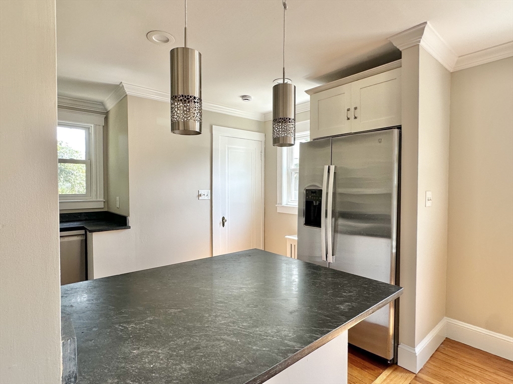 8 A Mellon Road Wellesley, MA 02482 - Photo 3 of 22 a kitchen with stainless steel appliances granite countertop a refrigerator a sink and a stove