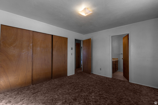 1208 East Tidwell Road Loa, UT 84747 - Photo 22 of 40 Unfurnished bedroom featuring light colored carpet, a closet, and ensuite bathroom