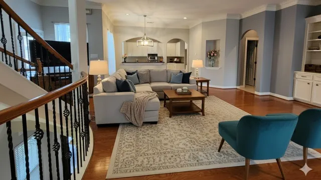 a living room with furniture wooden floor and a flat screen tv