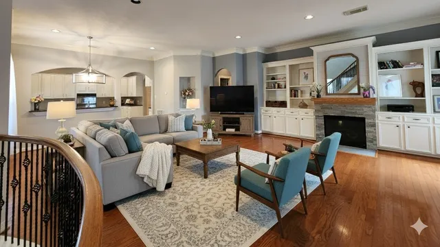a living room with fireplace furniture and a wooden floor