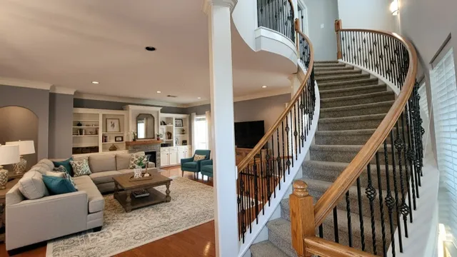 a living room with furniture and stairs