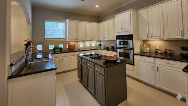 a kitchen with stainless steel appliances granite countertop a stove a sink dishwasher and a refrigerator