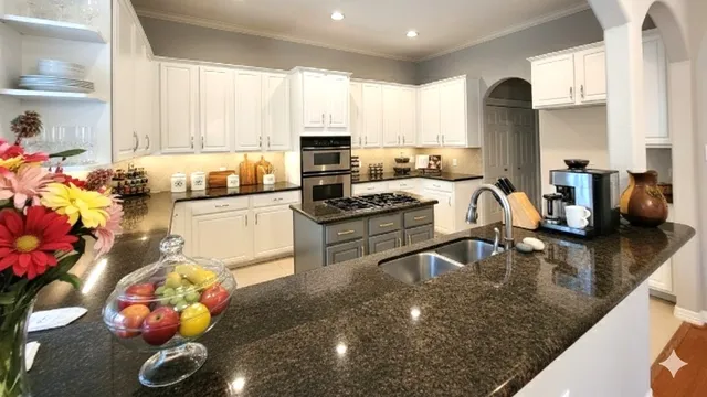 a kitchen with a sink a stove and cabinets