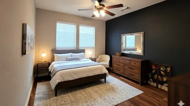 a bedroom with a bed and a dresser with wooden floor