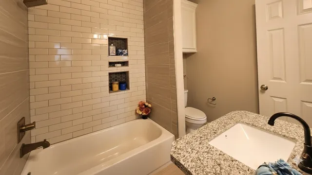 a bathroom with a tub sink and mirror