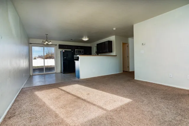 a view of a hallway with wooden floor and windows