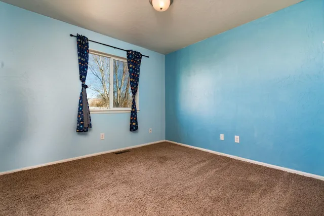 an empty room with windows and entrance