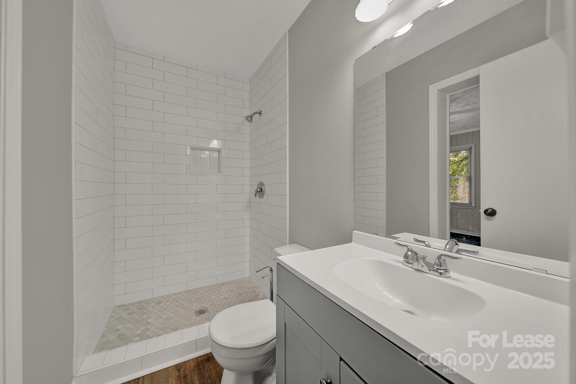 515 Wilcrest Drive Matthews, NC 28105 - Photo 11 of 19 a bathroom with a sink toilet and shower