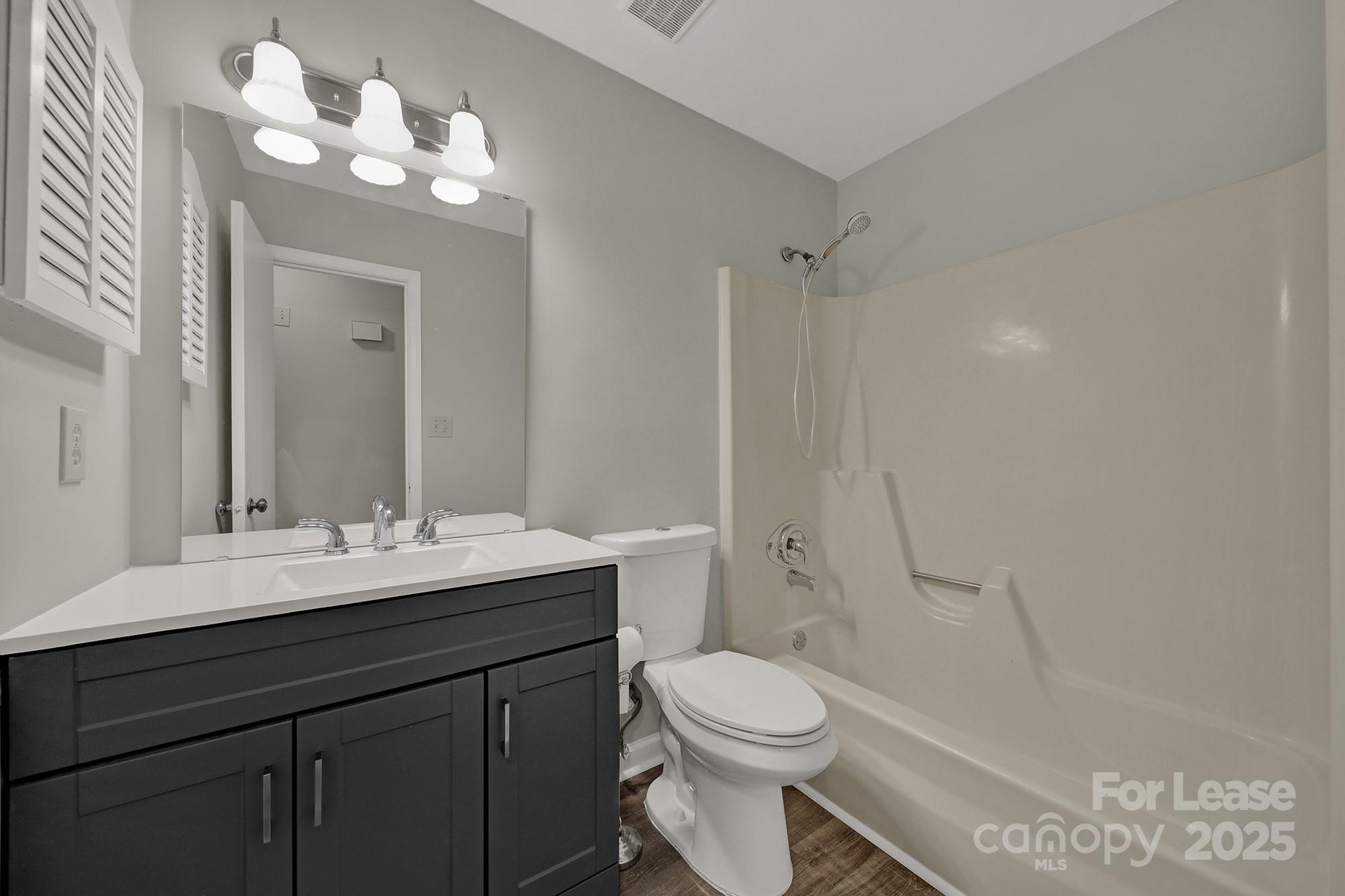 515 Wilcrest Drive Matthews, NC 28105 - Photo 12 of 19 a bathroom with a toilet a sink a mirror and vanity