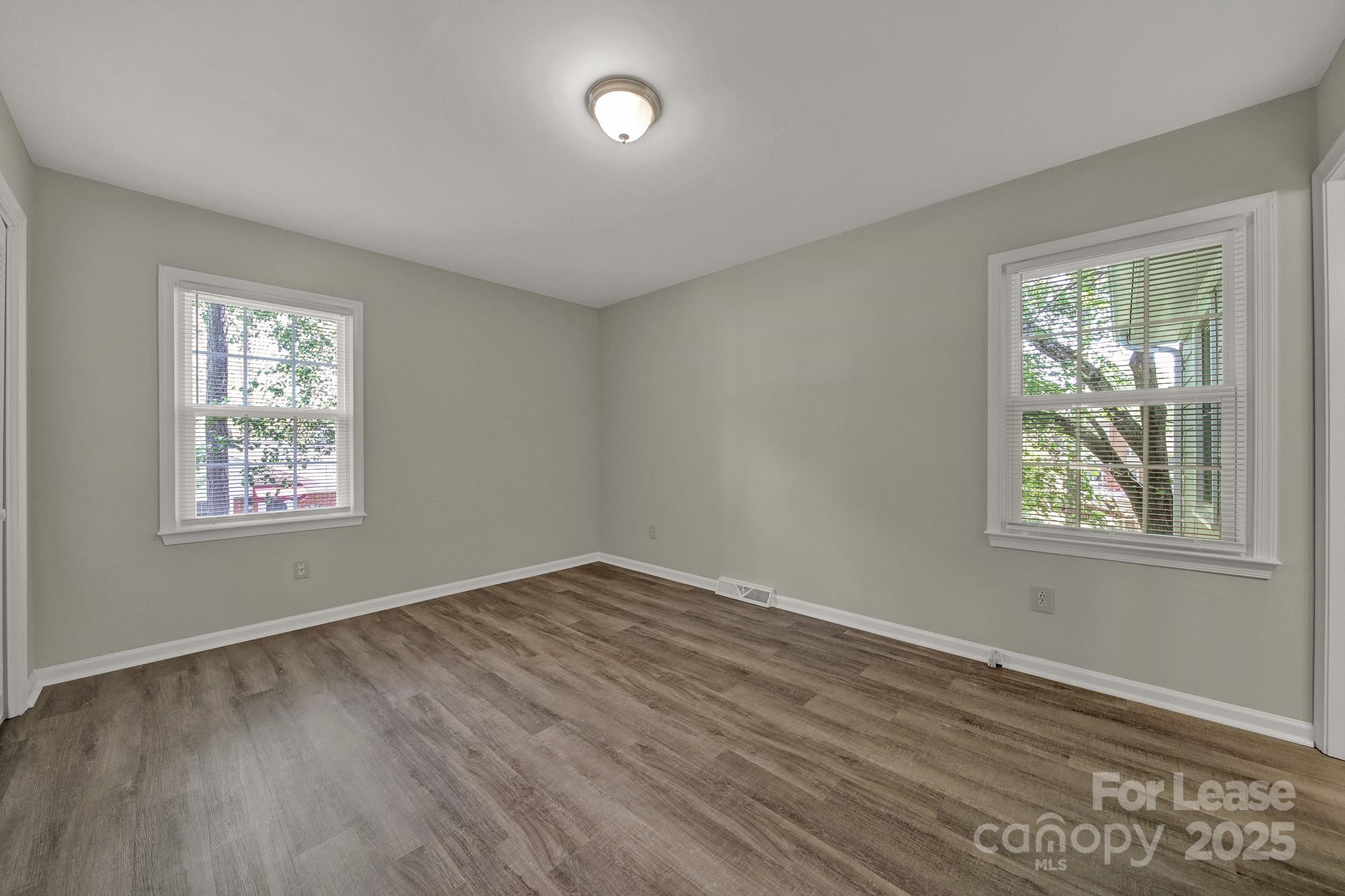 515 Wilcrest Drive Matthews, NC 28105 - Photo 14 of 19 a view of an empty room with wooden floor and a window