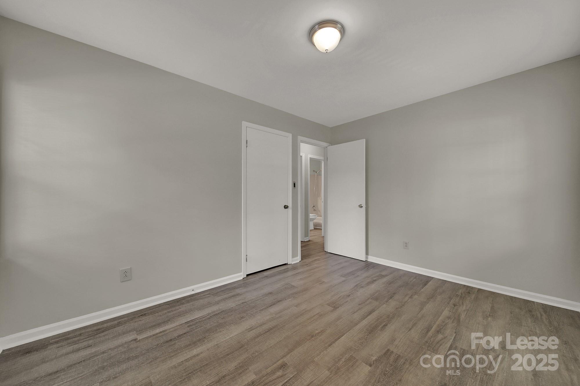 515 Wilcrest Drive Matthews, NC 28105 - Photo 16 of 19 an empty room with wooden floor and windows