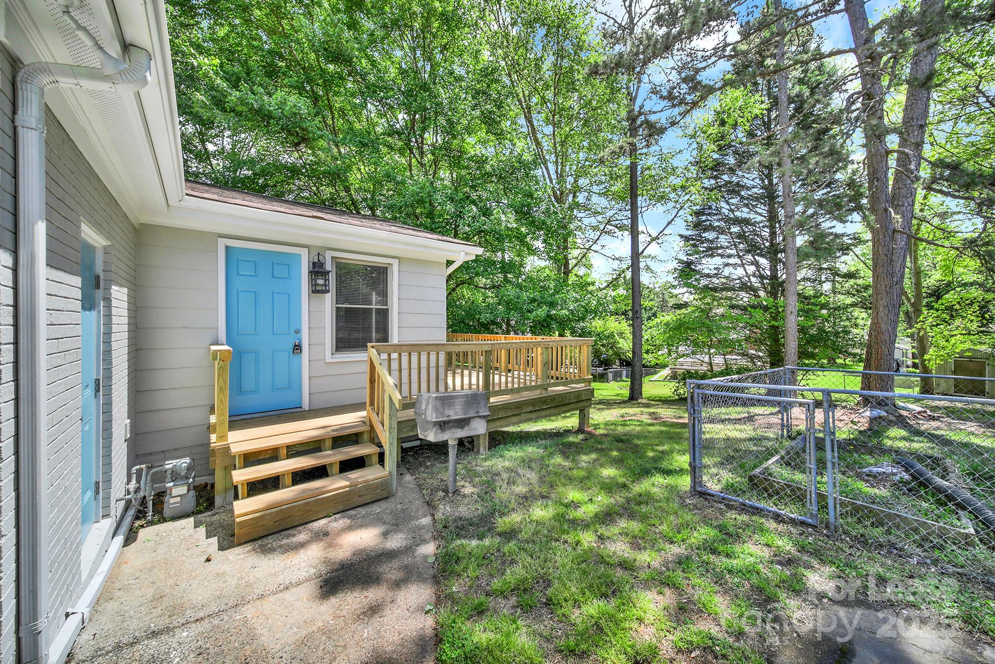 515 Wilcrest Drive Matthews, NC 28105 - Photo 19 of 19 a view of a chair and tables in the back yard of the house