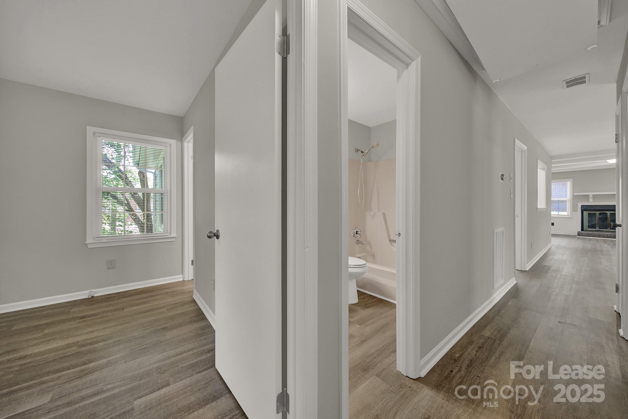 515 Wilcrest Drive Matthews, NC 28105 - Photo 4 of 19 a view of a hallway with wooden floor and a living room