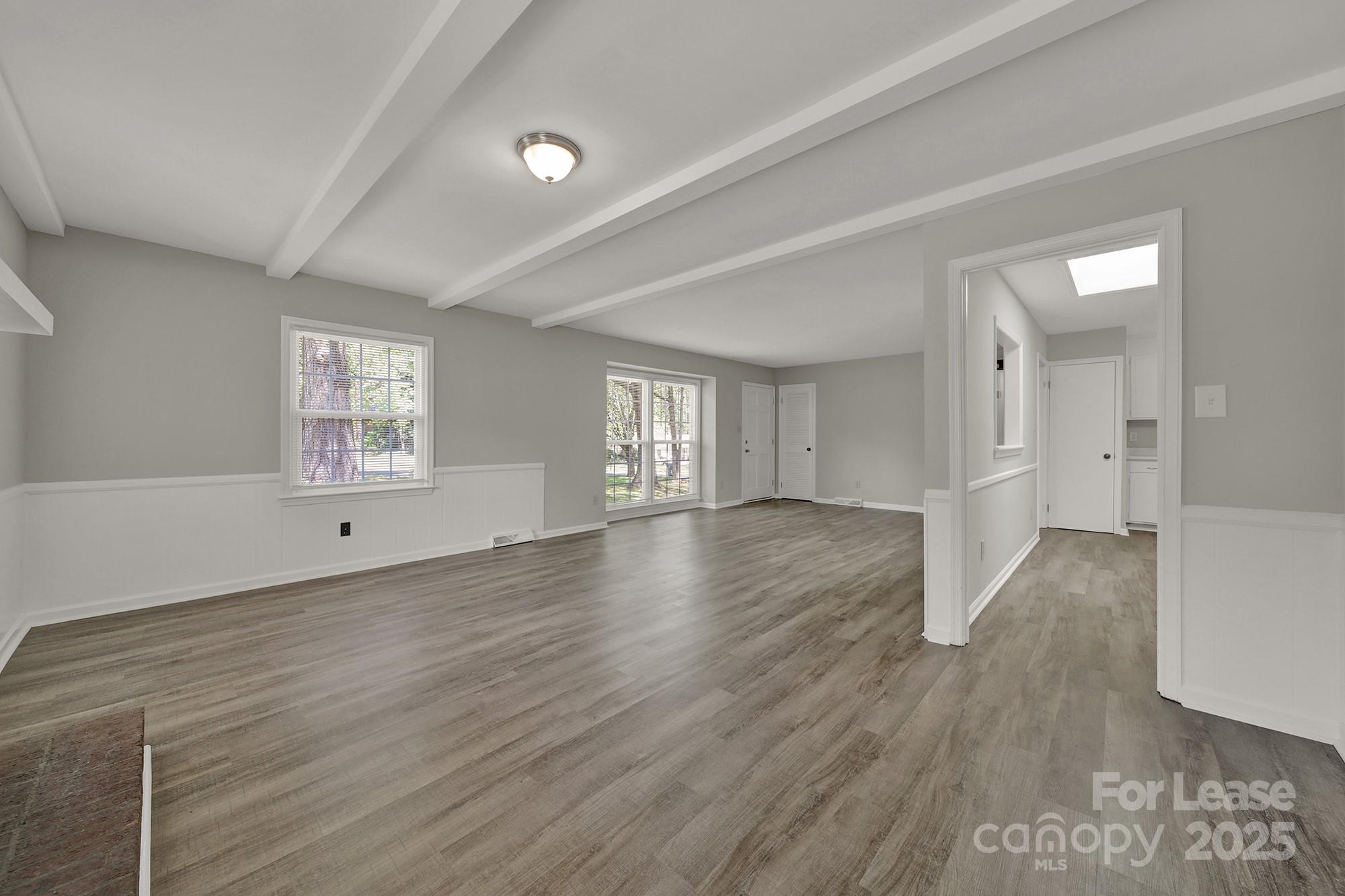 515 Wilcrest Drive Matthews, NC 28105 - Photo 5 of 19 wooden floor in an empty room with a window