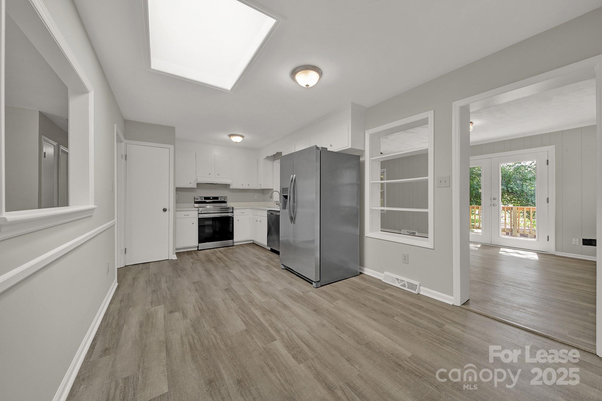 515 Wilcrest Drive Matthews, NC 28105 - Photo 6 of 19 a view of an empty room with wooden floor and a window