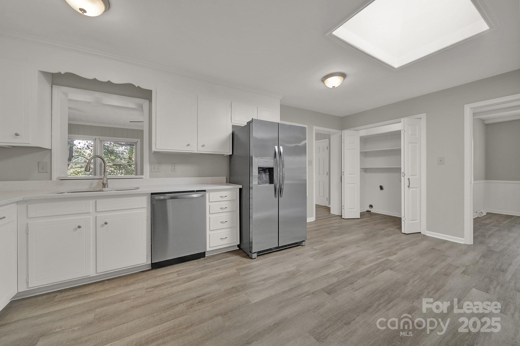 515 Wilcrest Drive Matthews, NC 28105 - Photo 7 of 19 a kitchen with a refrigerator sink and cabinets