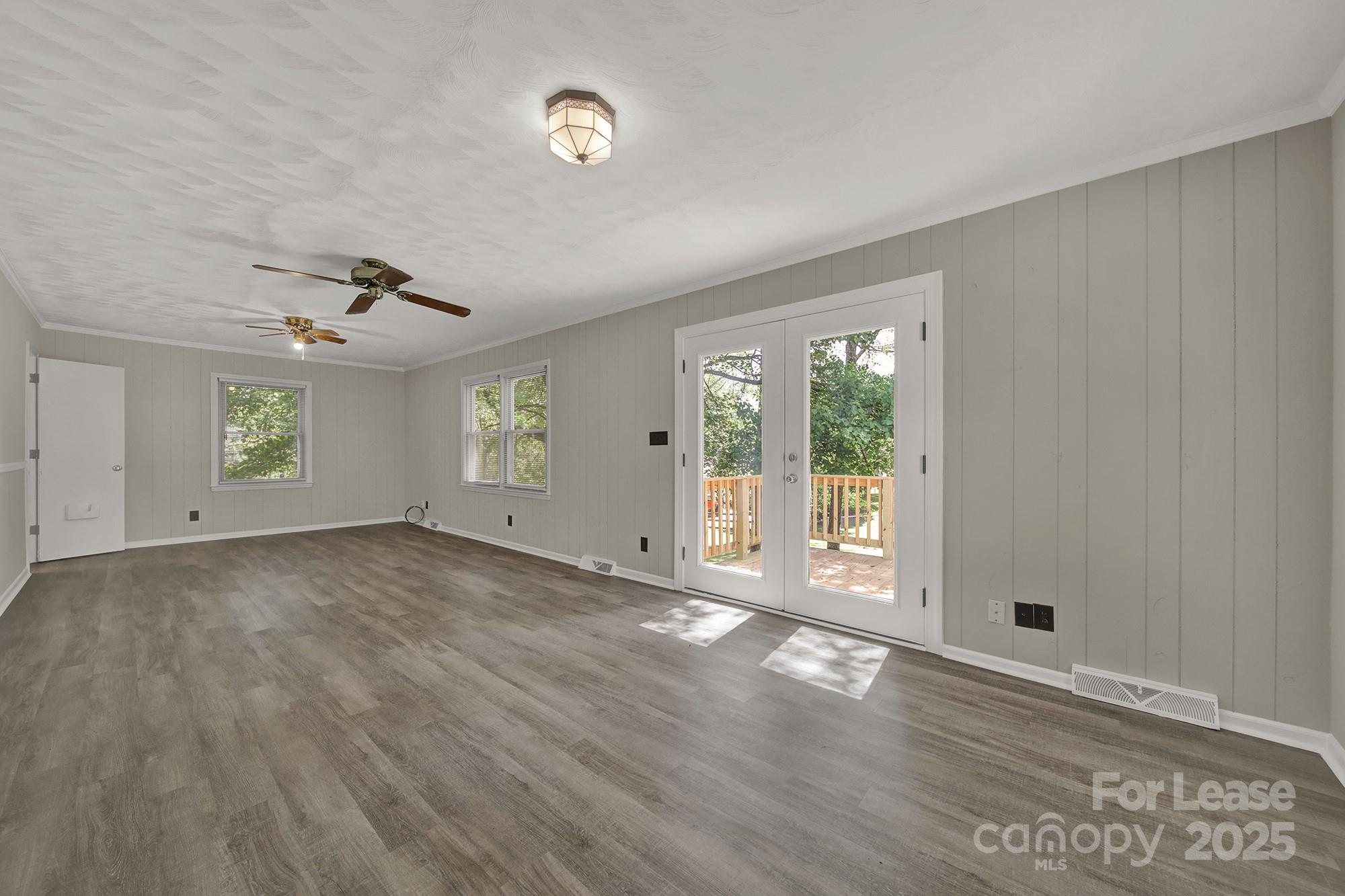 515 Wilcrest Drive Matthews, NC 28105 - Photo 8 of 19 an empty room with wooden floor and windows